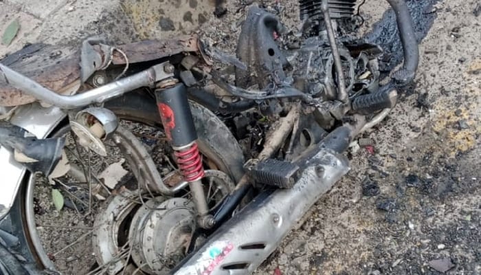 The picture shows a damaged motorcycle on Peshawars Board Bazar road on March 10, 2024. — Reporter