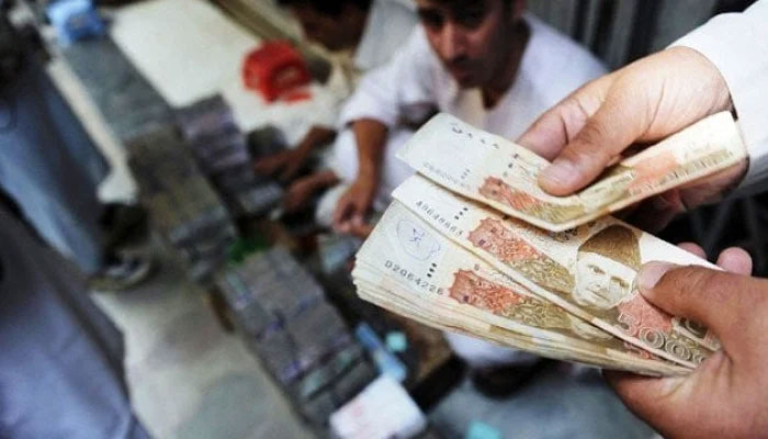 A person counting Pakistani currency notes. — AFP/File
