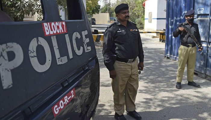 Police stand guard on a street in Karachi. — AFP/File