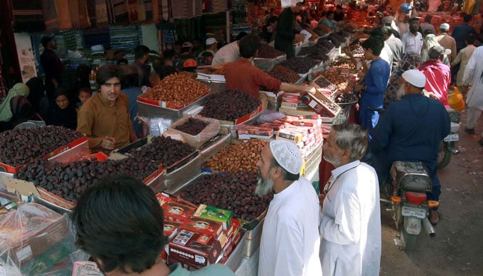Dates are being selling on roadside stall as a demand of Dates increase on the arrival of the Holy Month of Ramadan-ul-Mubarak, located on Lea Market in Karachi on March 11, 2024. — PPI