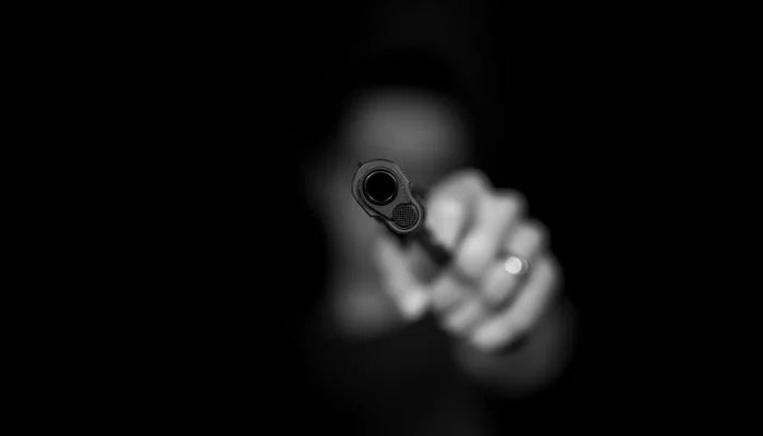 A representational image of a person taking aim with a gun. — Unsplash/File