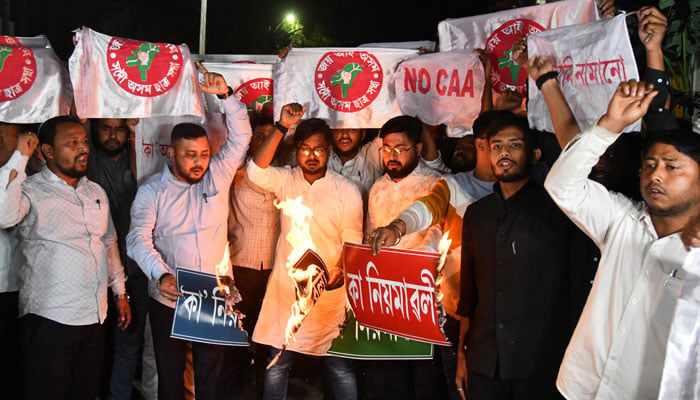 Activists of All Assam Students Union (AASU) set alight copies of the Indian governments Citizenship Amendment Act (CAA) during a protest in Guwahati on March 11, 2024. — AFP