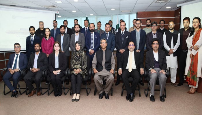Chairman CCP, Dr Kabir Ahmed Sidhu, and Member Advocacy Mr Salman Amin, with the participants at a Training Workshop on Guidance on Competition Compliance (GCC). — x/CCP_Pakistan/File