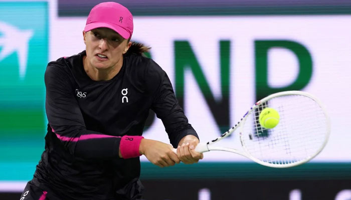 Iga Swiatek of Poland plays a backhan against Yulia Putintseva of Kazakhstan in their fourth round match during the BNP Paribas Open at Indian Wells Tennis Garden on March 12, 2024. — AFP