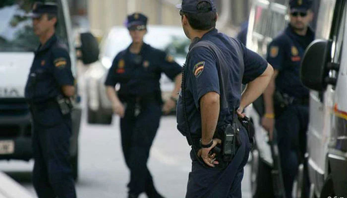 Spanish police personnel stand alert on the road. — AFP/File