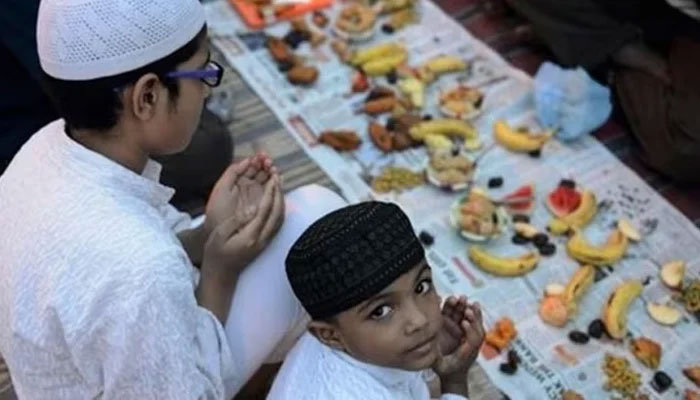 Children say their prayers before breaking fast during the holy month of Ramadan. — AFP/File