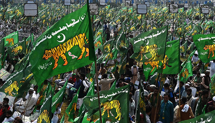 PML-N supporters waive party plags during a political gathering in Lahore. — AFP/File
