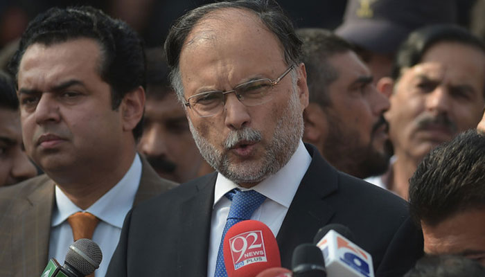 Pakistani Planning Minister Ahsan Iqbal, center, speaks to media outside an accountability court in Islamabad on Oct 2, 2017. —AFP/File