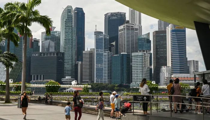 People gather outside the ArtScience Museum at Marina Bay Sands in Singapore on January 17, 2023. —AFP