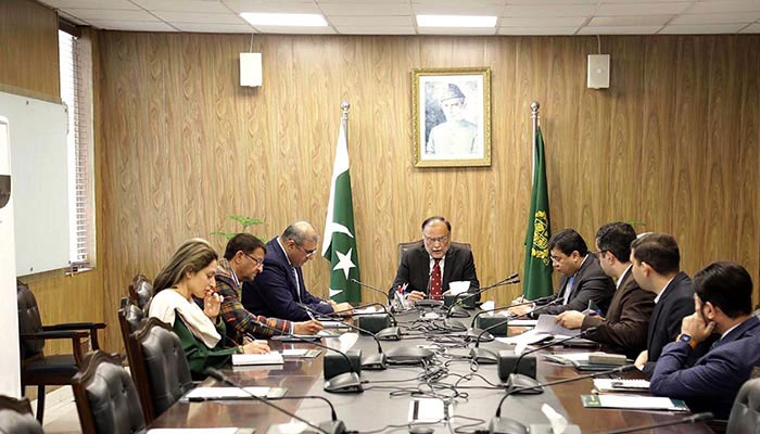Federal Minister for Planning Development & Special Initiatives Professor Ahsan Iqbal (centre) chairs a meeting. — APP/File