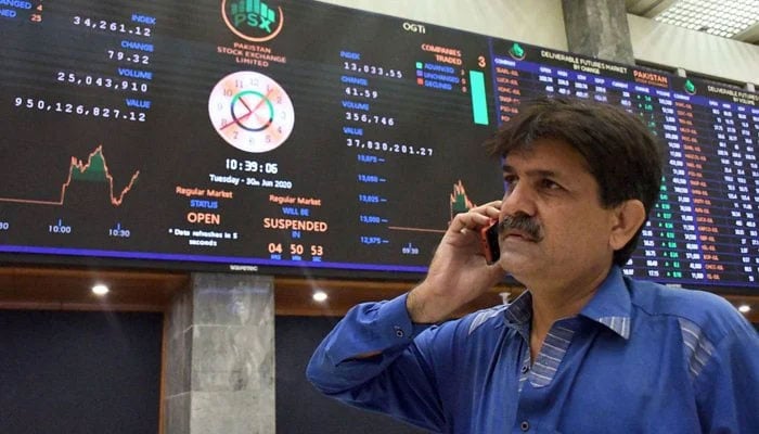 A trader is busy on call as resumes business at the Pakistan Stock Exchange (PSX) building in Karachi. — PPI/Files