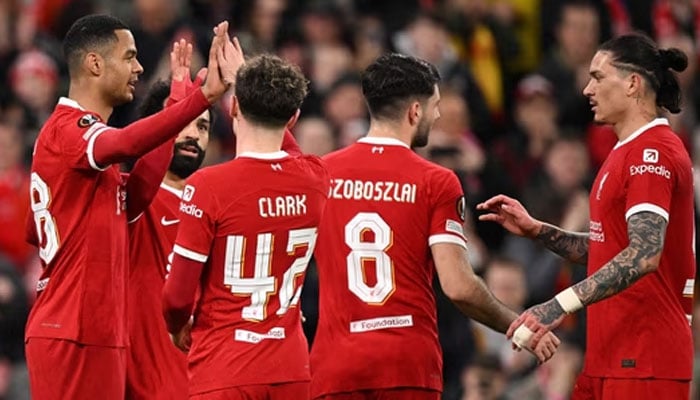 Liverpool players celebrate scoring a goal during a match.— AFP/File