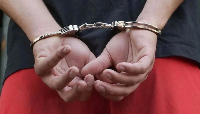 A representational image of a handcuffed man. — Pexels