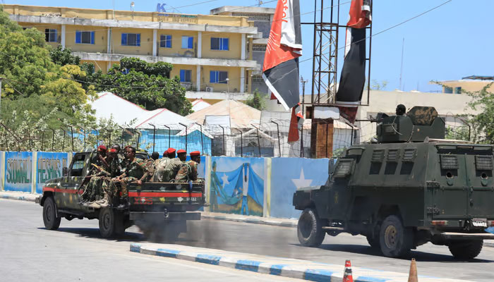 An armoured personnel carrier (APC) drives in a street near a hotel in Mogadishu on March 15, 2024. —AFP