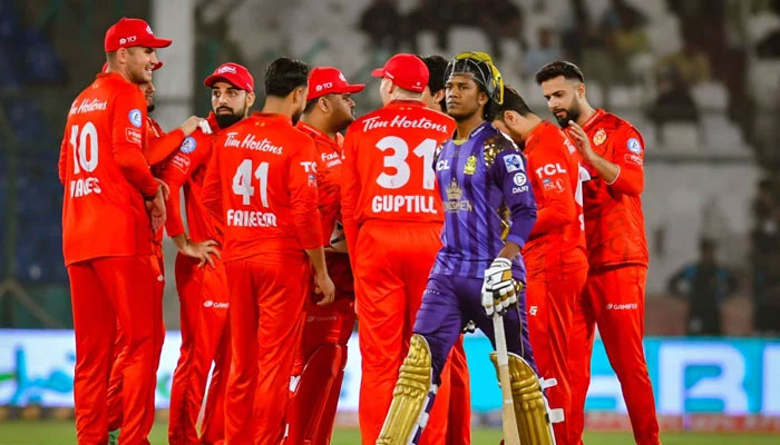 Islamabad United players celebrate as Quetta Gladiators Akeal Hosein walks back to the pavilion during PSL match on March 15, 2024. — X/@thePSLt20