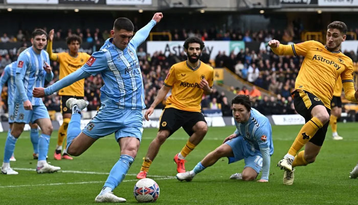 Coventry Citys English defender Bobby Thomas (C) clears the ball during the English FA Cup quarter-final football match between Wolverhampton Wanderers and Coventry City at the Molineux stadium in Wolverhampton, central England on March 16, 2024. — AFP