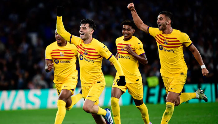 Barcelona players can be seen running while celebrating during a match. — AFP/File