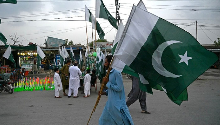 A man carrying Pakistani flags in this undated photo.—AFP/File