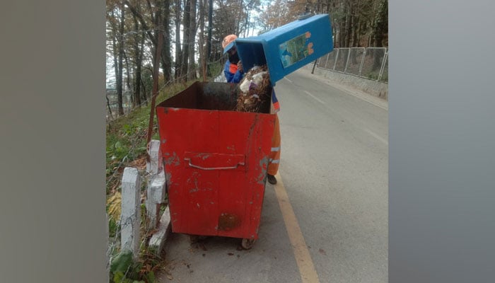 An employee of the RWMC dispose of garbage in a cleanliness campaign on November 20, 2023. — Facebook/Rawalpindi Waste Management Company
