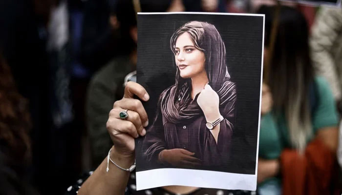 A protester holds a portrait of Mahsa Amini during a demonstration in her support in front of the Iranian embassy in Brussels, Belgium, September 23, 2022. — AFP/File