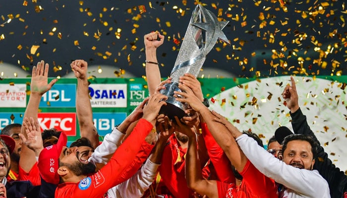 Islamabad United skipper Shadab Khan lifts PSL 9 trophy along with his team after winning the tournaments final in Karachis National Bank Stadium on March 18, 2024. — X/@thePSLt20