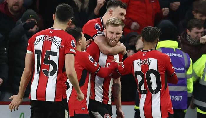 Sheffield Uniteds Ollie McBurnie (centre) celebrates with teammates after scoring a penalty. — AFP/File