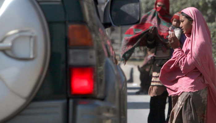 A  female beggar gestures as she begs for alms at a roadside on March 7, 2024. — PPI