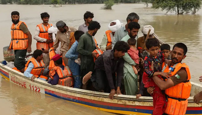 Rescue workers seen helping people amid floods on 2022-23 in Pakista in this file photo.—AFP/File