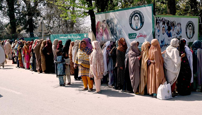 A large number of women stand in a queue to draw money from Benazir Income Support Programme (BISP) beneficiaries outside Benazir One Window Center at G-7 on March 19, 2024. — APP