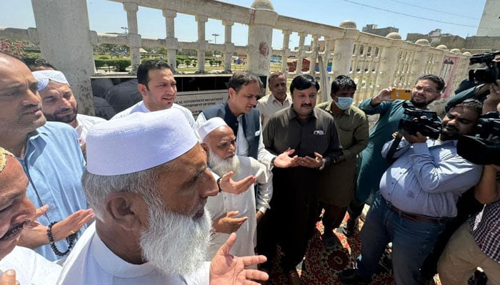 Karachi Mayor Barrister Murtaza Wahab (C) offers Fateha during the lays the foundation stone for the paving work of roads and streets in Orangi Town on March 21, 2024. — Facebook/Barrister Murtaza Wahab