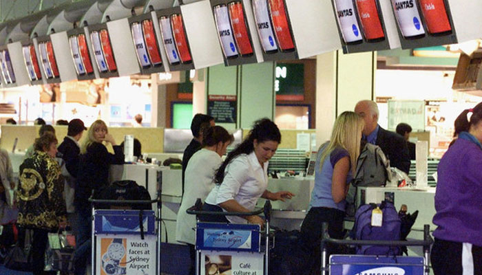 Passengers check in at the refurbished Sydney International Airport Terminal. — AFP/File