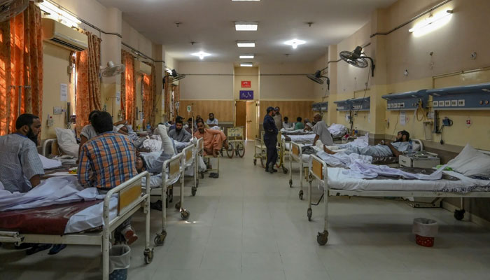 The photograph shows a male ward in a Pakistani hospital. — AFP/File