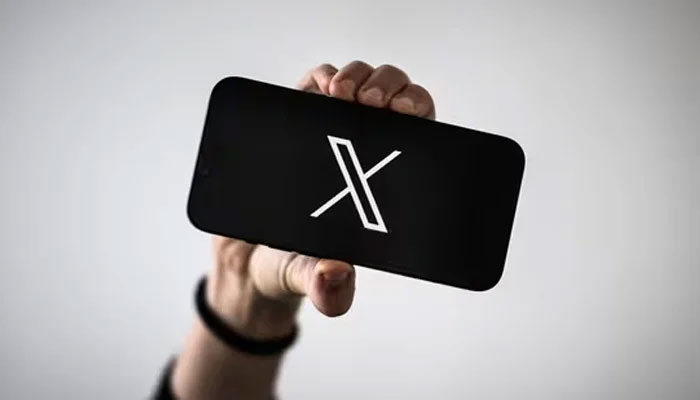 A person holds a smartphone displaying the logo of the social media platform, X. — AFP/File