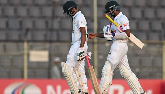 Bangladeshs Taijul Islam (L) and Mahmudul Hasan Joy walk back to the pavilion at the end of the first day of the first Test cricket match between Bangladesh and Sri Lanka at the Sylhet International Cricket Stadium in Sylhet on 22 March, 2024. — AFP