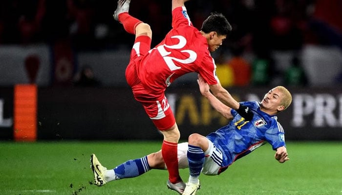 North Koreas Kim Kuk Bom clashes with Japans Daizen Maeda during their World Cup qualifier in Tokyo. — AFP/File