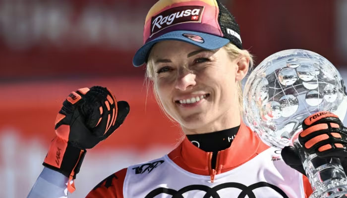 Switzerlands Lara Gut-Behrami celebrates with the globe of the overall seasons super-G winner in the finish area after the super-G event in Saalbach, Austria on Friday. — AFP