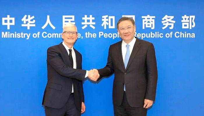 China’s Minister of Commerce Wang Wentao (right) shake hands with Tim Cook, CEO of Apple on March 22, 2024. — Facebook/中华人民共和国商务部 MOFCOM