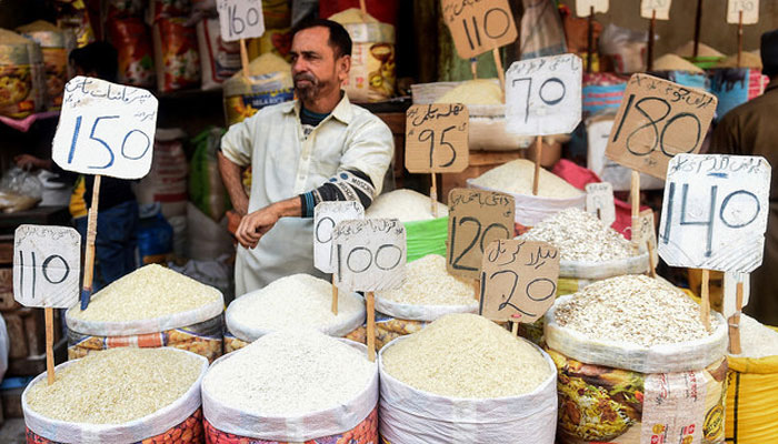 A shopkeeper waits for customers at a market in Karachi on January 10, 2022. — AFP