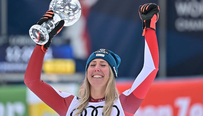 Cornelia Huetter celebrates her first crystal globe in the World Cup downhill at home in Saalbach, Austria.—  AFP/File