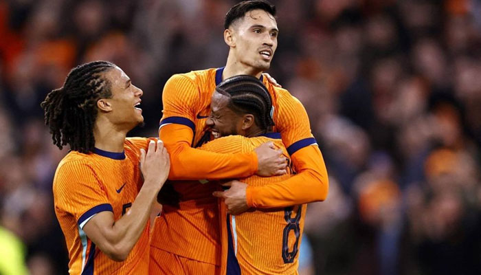 Tijjani Reijnders (C) celebrates scoring the Netherlands first goal with Nathan Ake (L) and Georginio Wijnaldum (R) during the international friendly football match between the Netherlands and Scotland at the Johan Cruijff Arena in Amsterdam on March 22, 2024. — AFP