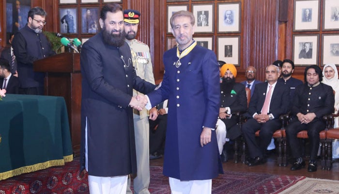 King Edward Medical University (KEMU) Vice Chancellor Prof Mahmood Ayyaz (right) shakes hand with Punjab Governor Baligh-ur-Rehman after receiving Sitara-e-Imtiaz in a ceremony held at Governor House on March 23, 2024. — Facebook/Muhammad Umar Warraich
