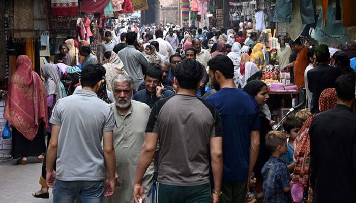 People throng a market area in Lahore, Pakistan. — AFP/File