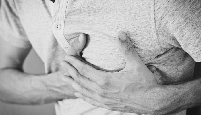 A representational image showing a person feeling chest pains due to a heart disease. — Pexels