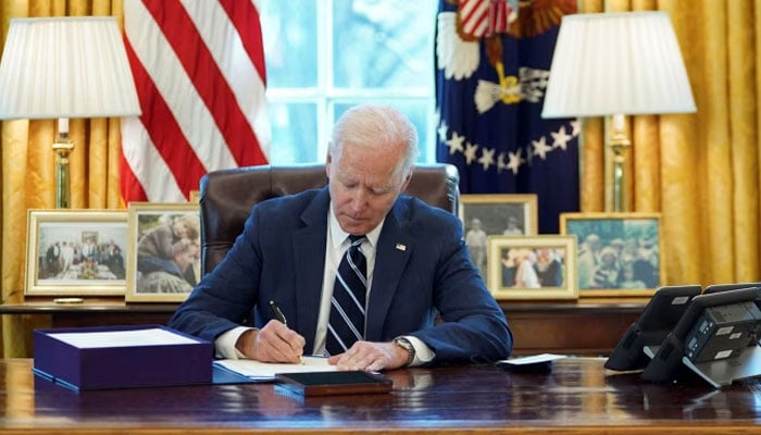 Representational image showing US President Joe Biden signing a document. — AFP/File