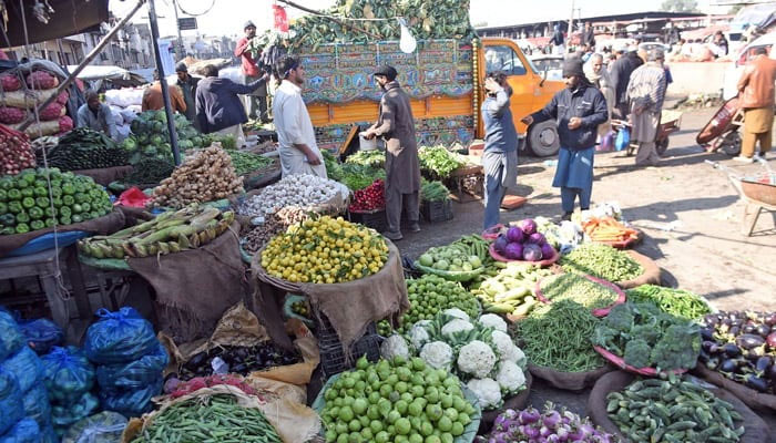 Vendors are selling vegetables at the fruits and vegetable market. — Online/File