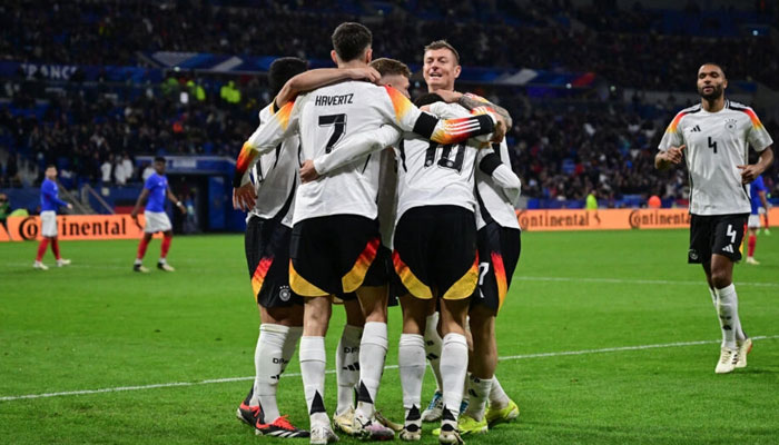 Germanys players celebrate after scoring their second goal against France at the Groupama Stadium in Lyon on March 23, 2024. — AFP