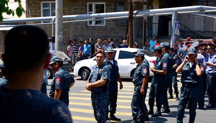 Armenian police officers stand on the street. — AFP/File