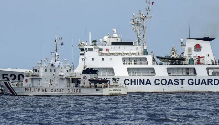 Chinese coast guard ship pictured alongside Phillippine coastguard vessel. — AFP/File