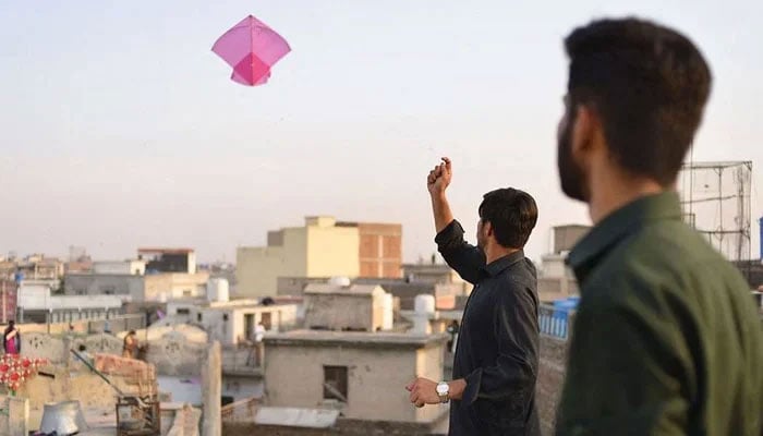 This image shows a person flying a kite. — AFP/File