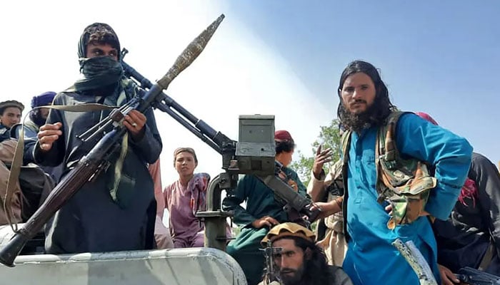 Armed Taliban fighters seen a top of a military vehicle in Afghantans Laghman province. — AFP/File
